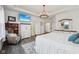 Bright main bedroom boasts a tray ceiling, stylish chandelier, media center, and doorway leading to a bathroom at 1295 Clairet Dr, Westfield, IN 46074