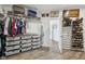 Organized walk-in closet with shelves, hanging racks, drawers, and hardwood flooring throughout at 1295 Clairet Dr, Westfield, IN 46074