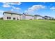 Expansive backyard view showcasing the green lawn and neighboring houses in a suburban setting at 12951 Corydon Dr, Fishers, IN 46037