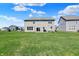 A spacious backyard featuring a two-story home, green lawn, and neighborhood views at 12951 Corydon Dr, Fishers, IN 46037