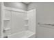 A bathroom tub with white walls and chrome fixtures, complemented by neutral walls and a towel rack at 12951 Corydon Dr, Fishers, IN 46037