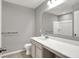 A bathroom vanity with a white countertop and a large mirror, complemented by neutral walls and modern fixtures at 12951 Corydon Dr, Fishers, IN 46037