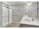 Well-lit bathroom featuring a double vanity with chrome fixtures and a glass shower enclosure at 12951 Corydon Dr, Fishers, IN 46037