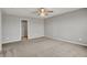 This carpeted bedroom features a ceiling fan and an open closet space for organized storage at 12951 Corydon Dr, Fishers, IN 46037