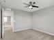 A serene bedroom featuring neutral walls, carpet, trim and a ceiling fan light, with a door leading to the hallway at 12951 Corydon Dr, Fishers, IN 46037