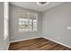 Bedroom with hardwood flooring, a modern ceiling fan, a large window offering lots of natural light at 12951 Corydon Dr, Fishers, IN 46037