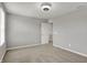 A bright bedroom featuring neutral walls, carpet, trim and a ceiling fan light, with a door leading to another room at 12951 Corydon Dr, Fishers, IN 46037