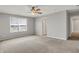 Spacious bedroom featuring neutral carpet, ceiling fan, and a sunlit window at 12951 Corydon Dr, Fishers, IN 46037