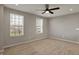 An inviting bedroom with carpet, a ceiling fan, and ample natural light from the windows at 12951 Corydon Dr, Fishers, IN 46037