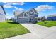 Attractive home with a two-car garage, well-kept lawn and extended driveway at 12951 Corydon Dr, Fishers, IN 46037