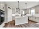 Modern kitchen featuring an island, stainless steel appliances, and stylish pendant lighting at 12951 Corydon Dr, Fishers, IN 46037