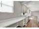 Bright kitchen area featuring white countertops and cabinets, with stainless steel appliances and wood flooring at 12951 Corydon Dr, Fishers, IN 46037