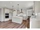 Open concept kitchen with island, stainless appliances, and hardwood flooring at 12951 Corydon Dr, Fishers, IN 46037