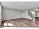 Inviting living room with wood flooring, recessed lighting, and a staircase leading to the upper level at 12951 Corydon Dr, Fishers, IN 46037