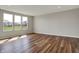 Living room featuring wood floors, recessed lighting, and large windows showcasing the backyard at 12951 Corydon Dr, Fishers, IN 46037
