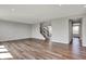 Spacious living room with wood flooring and staircase leading to the upper level, offering ample space at 12951 Corydon Dr, Fishers, IN 46037