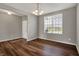 Inviting room with modern flooring, a chandelier, and view of the entryway and the front yard at 12951 Corydon Dr, Fishers, IN 46037