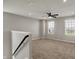 This loft features plush carpet, a ceiling fan, and natural light, offering a cozy retreat at 12951 Corydon Dr, Fishers, IN 46037