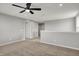 Spacious carpeted loft with a ceiling fan, abundant natural light, and access to other rooms at 12951 Corydon Dr, Fishers, IN 46037