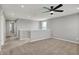 A cozy loft with plush carpet, a ceiling fan, and natural light, perfect for relaxation or entertainment at 12951 Corydon Dr, Fishers, IN 46037