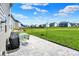 Paver patio and backyard featuring a grill and partially covered furniture for outdoor entertaining at 12951 Corydon Dr, Fishers, IN 46037