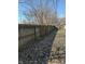 Large backyard is enclosed by a wooden fence that ensures privacy and has trees at 1342 W Lee St, Indianapolis, IN 46221