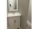 Bathroom featuring a white sink with cabinets, a mirror, and neutral wall paint at 1342 W Lee St, Indianapolis, IN 46221