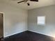 Neutral toned bedroom features dark laminated wood flooring, bright walls and standard ceiling fan at 1342 W Lee St, Indianapolis, IN 46221