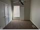 Bedroom features carpet floors, a ceiling fan, and a window with blinds for natural light at 1342 W Lee St, Indianapolis, IN 46221