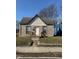 Charming single-story home with brick facade and inviting front porch steps to the entry door at 1342 W Lee St, Indianapolis, IN 46221