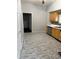 Functional kitchen featuring wood cabinets, modern stainless dishwasher, and easy-to-clean tile floors at 1342 W Lee St, Indianapolis, IN 46221