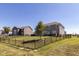 This backyard is surrounded by a black metal fence, offering privacy and security at 1370 Timber Bluff Rd, Westfield, IN 46074