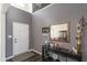 Welcoming entryway features modern decor, a dark wood accent table, and staircase leading to upper floors at 1370 Timber Bluff Rd, Westfield, IN 46074