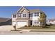 Charming two-story home with a three car garage, brick accents and manicured lawn at 1370 Timber Bluff Rd, Westfield, IN 46074