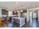 Bright, modern kitchen with a large island, stainless steel appliances, and dark wood cabinets at 1370 Timber Bluff Rd, Westfield, IN 46074