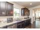 Charming kitchen features granite countertops, stainless steel appliances, and dark wood cabinets at 1370 Timber Bluff Rd, Westfield, IN 46074