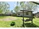 Private backyard featuring a swing set, a well-maintained lawn, and a storage shed for convenience at 1472 Maria Ave, Franklin, IN 46131