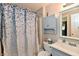 Bathroom featuring a shower with curtain, toilet, sink, vanity, and wall-mounted storage for essentials at 1472 Maria Ave, Franklin, IN 46131