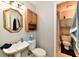 Bathroom featuring a pedestal sink, toilet, shower, and medicine cabinet for essential storage at 1472 Maria Ave, Franklin, IN 46131