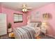 Cozy pink bedroom with neutral bedding, decorative shelves, and a large window at 1472 Maria Ave, Franklin, IN 46131