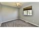 This bedroom features neutral walls, plush carpet, a ceiling fan, and natural light from the window at 1472 Maria Ave, Franklin, IN 46131
