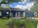 Charming single-story home featuring a well-manicured lawn, flower beds, and attached garage at 1472 Maria Ave, Franklin, IN 46131