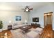 Bright living room featuring hardwood floors, a ceiling fan, sofa, and a mounted TV for entertainment at 1472 Maria Ave, Franklin, IN 46131