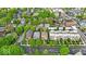 An aerial shot captures a neighborhood filled with mature trees, showcasing a mix of houses and townhomes at 1510 Central Ave, Indianapolis, IN 46202