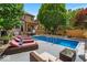 Inviting backyard pool area with lounge chairs, patio, landscaping, and pergola with hot tub at 1510 Central Ave, Indianapolis, IN 46202