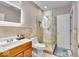 Well-lit bathroom with tiled shower, glass door, modern fixtures, and neutral color palette at 1510 Central Ave, Indianapolis, IN 46202