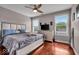 Comfortable bedroom with a ceiling fan, modern furniture, and bright natural light at 1510 Central Ave, Indianapolis, IN 46202