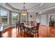 Elegant dining room with tray ceiling, hardwood floors, and chandelier at 1510 Central Ave, Indianapolis, IN 46202