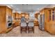 Bright kitchen featuring stainless steel appliances, wood cabinetry, tile flooring, and a center island with barstool seating at 1510 Central Ave, Indianapolis, IN 46202