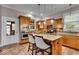 Modern kitchen featuring stainless steel appliances, wood cabinetry, and a center island with seating and pendant lighting at 1510 Central Ave, Indianapolis, IN 46202